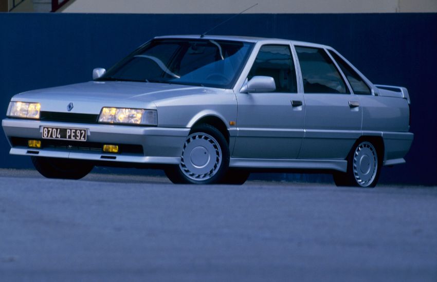 Front side view of a silver Renault classic car parked