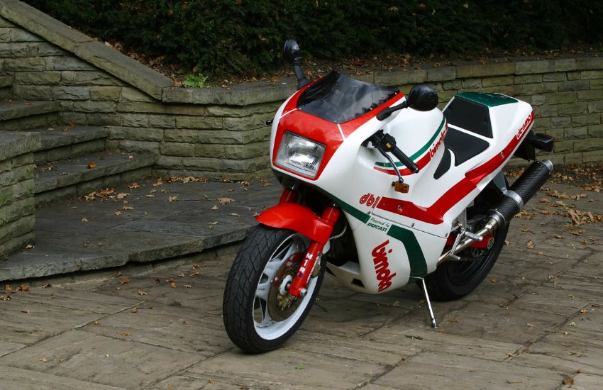 White, red and green Bimota DB1 classic motorbike parked up