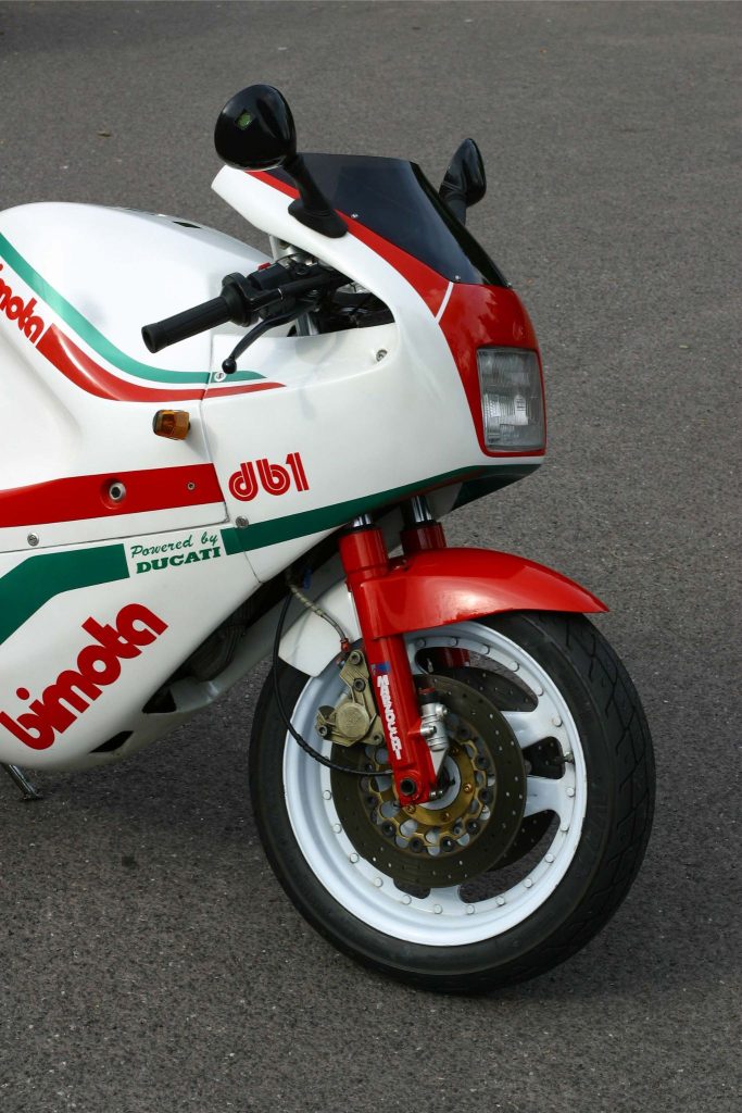 Front half of a white, red and green classic motorbike