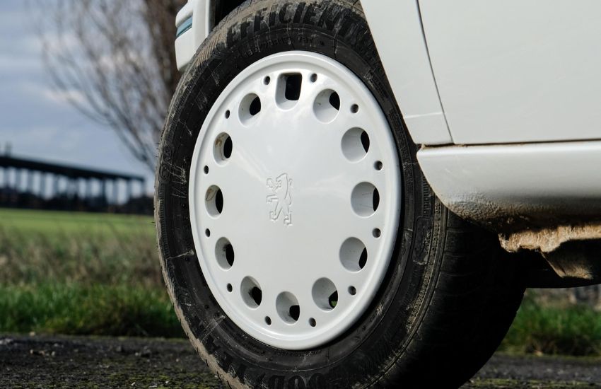 Close up of a white hubcap on a classic car