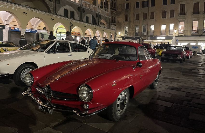 Red Alfa Romeo Giulietta Sprint Speciale parked in a car park at night time