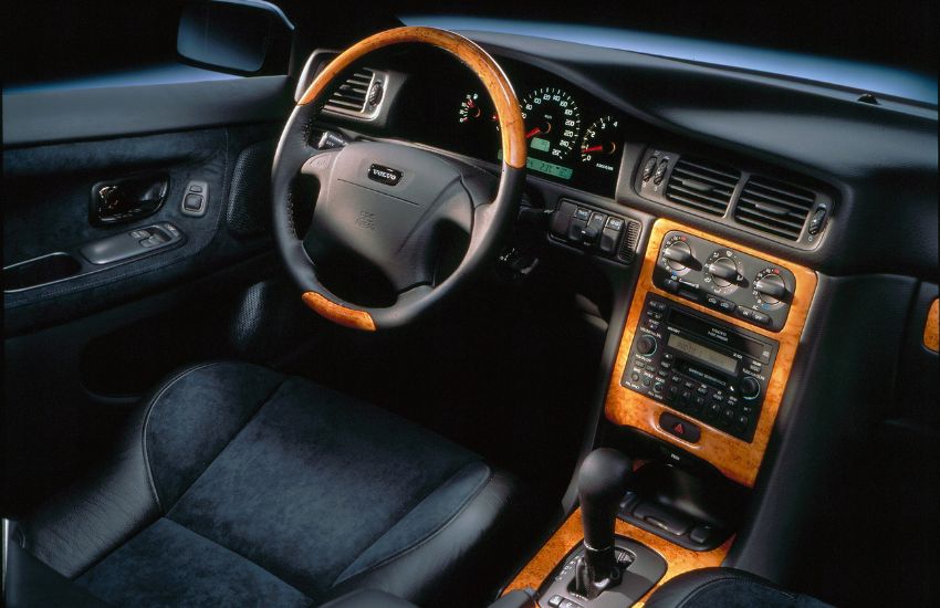 Black and wood veneer interior cabin of a car