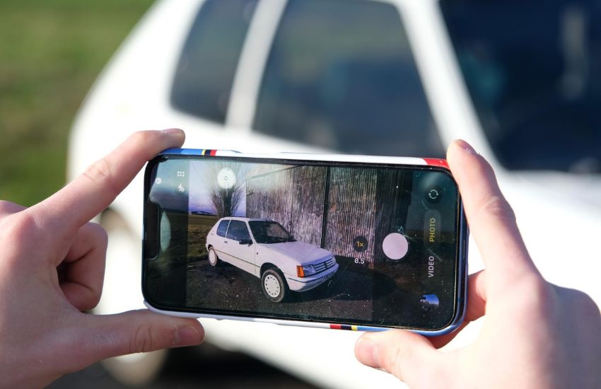 Photographer demonstrating how to photograph your car with an iphone