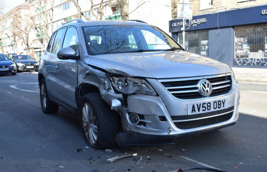 Total loss car with extensive front-end damage, illustrating insurance settlements that allow owners to retain the salvage