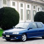 Blue Peugeot 306 modern classic car parked in front of a chateau