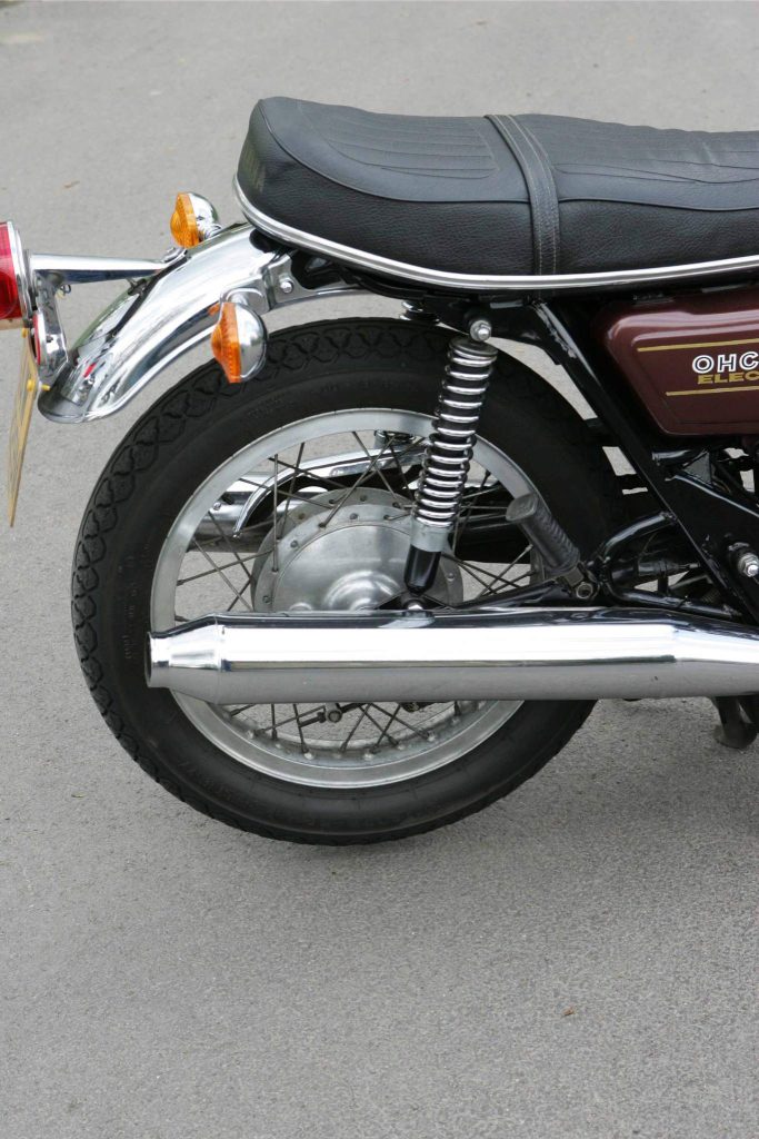 Rear wheel and exhaust of a classic Yamaha motorcycle