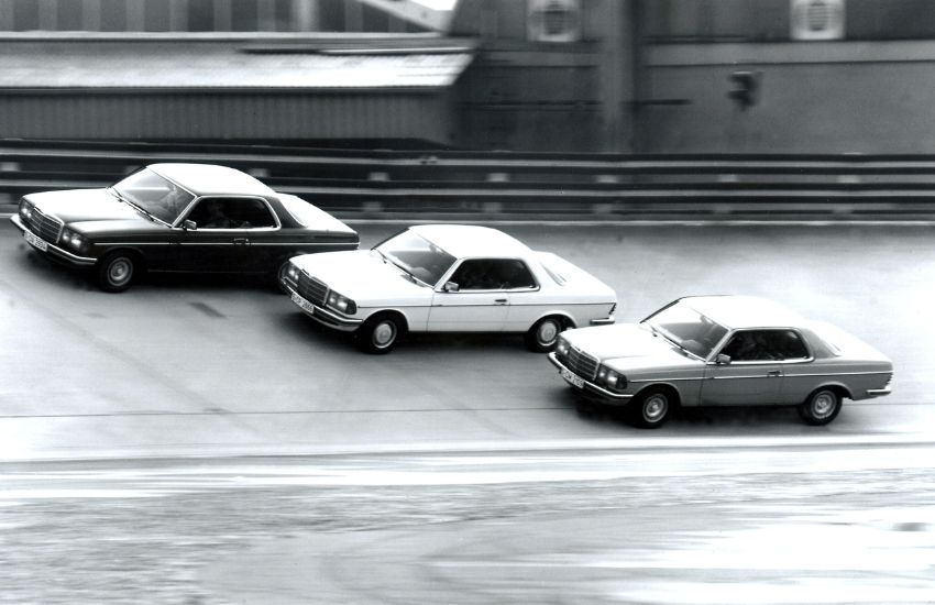 Three Mercedes W123 classic cars driving side by side along a road
