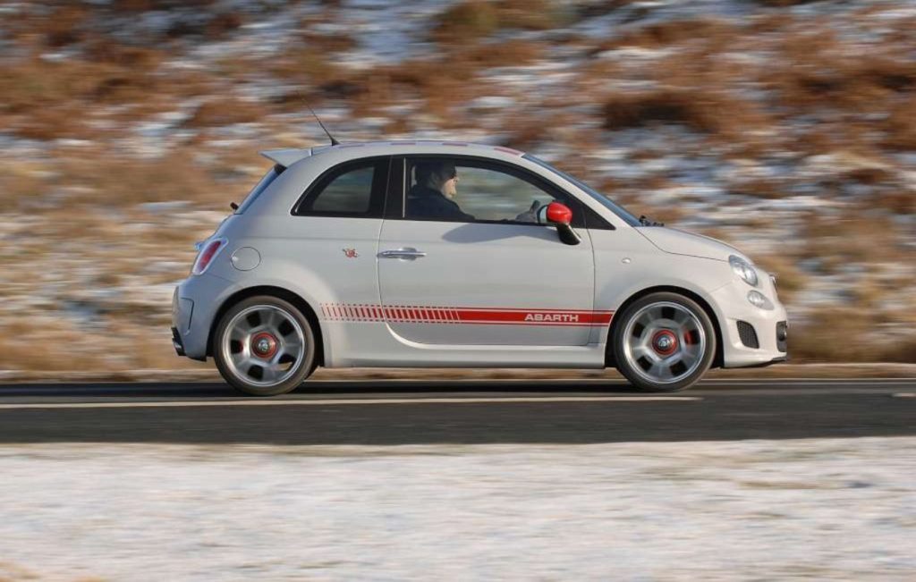 Man driving a Campovolo Grey Abarth 500 along a road