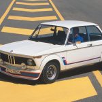 White BMW 02 Series parked across road with yellow paintwork