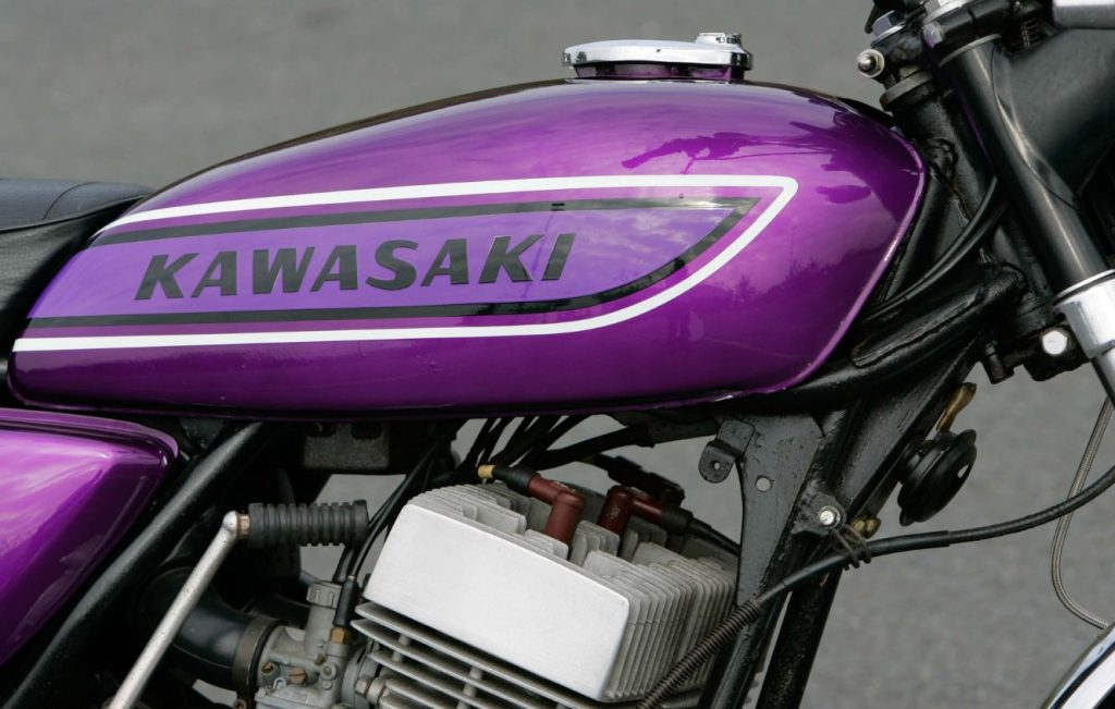 Metallic purple motorcycle fuel tank with Kawasaki sticker