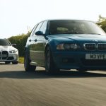 Two BMW M3 Touring (estate) models: a modern 2025/2026 version and a custom-built classic version driving along a road