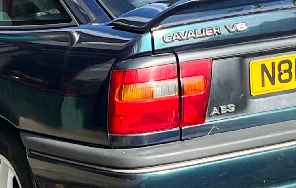 Rear quarter panel of a metallic blue Vauxhall Cavalier V6