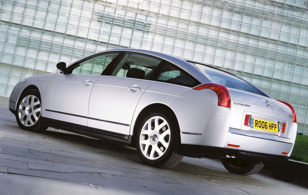 Rear side view of a silver parked up car