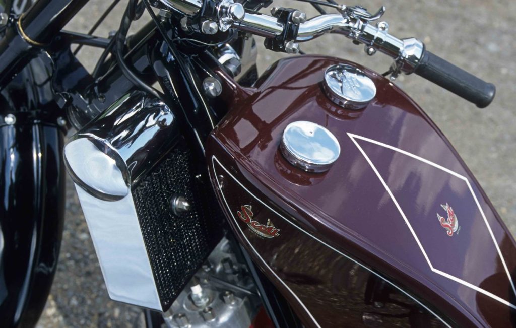 Cockpit and fuel tank assembly of a maroon classic motorcycle