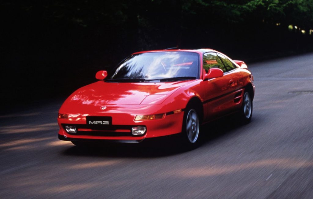 Red Toyota MR2 MK2 driving along a road