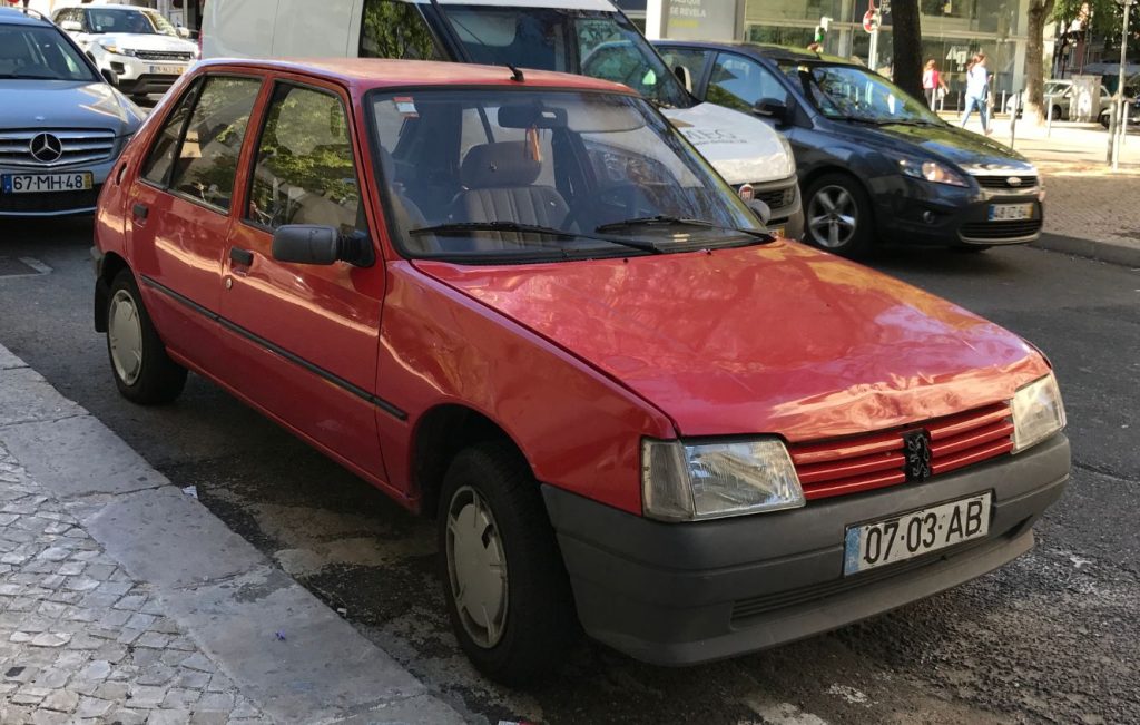 A Peugeot 205 supermini parked on a street