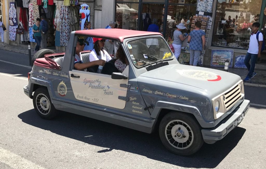 Renault 4 Mireli, a rare beach car variant based on the Renault 4L chassis being driven past storefronts