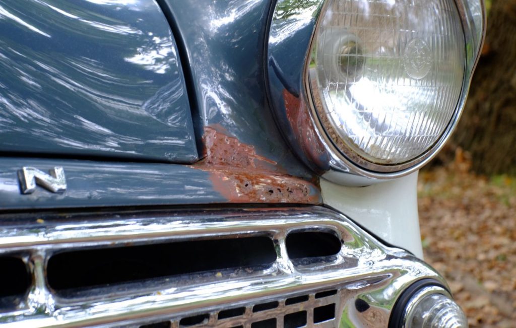 Front bumper of a blue Hillman Minx showing signs of rust