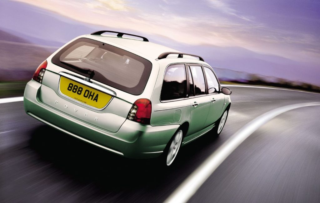 Rear view of a metallic green Rover 75 estate driving along a road