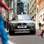 Rover Streetwise driving through city street surrounded by pedestrians front view
