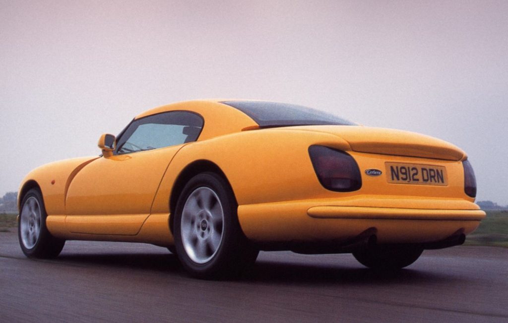 Rear side view of a yellow TVR Cerbera in motion