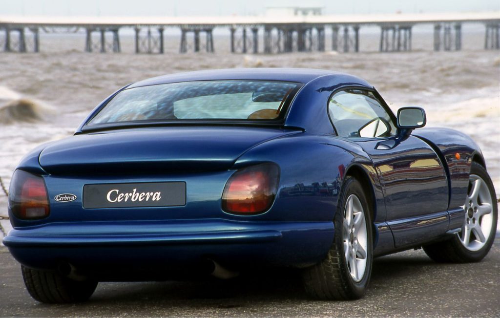 Rear view of a metallic TVR Cerbera parked in front of the sea on a windy day