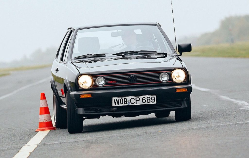 Man driving a black Volkswagen Polo G40