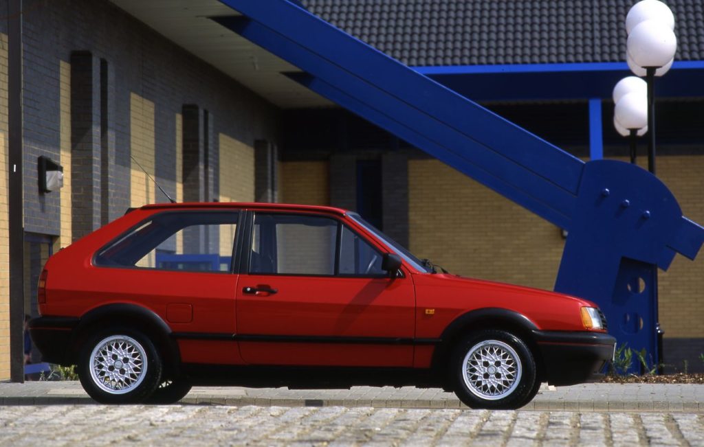 Side view of a parked red Volkswagen Polo G40