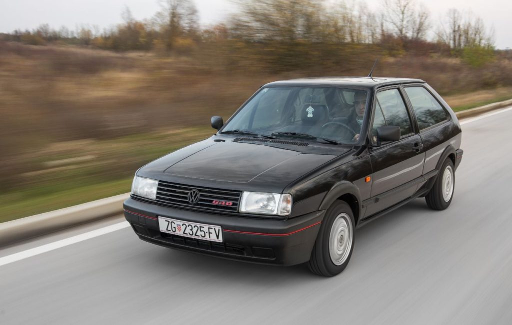 Man driving a black Volkswagen Polo G40