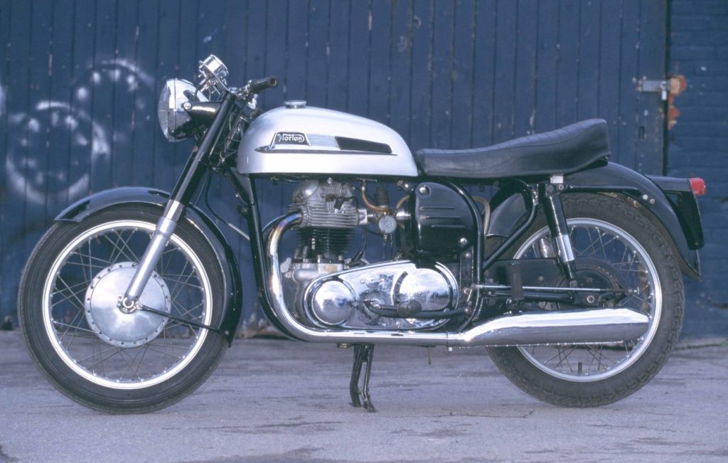 Norton Dominator 88 motorcycle parked outdoors, full left-side profile of restored classic British parallel twin