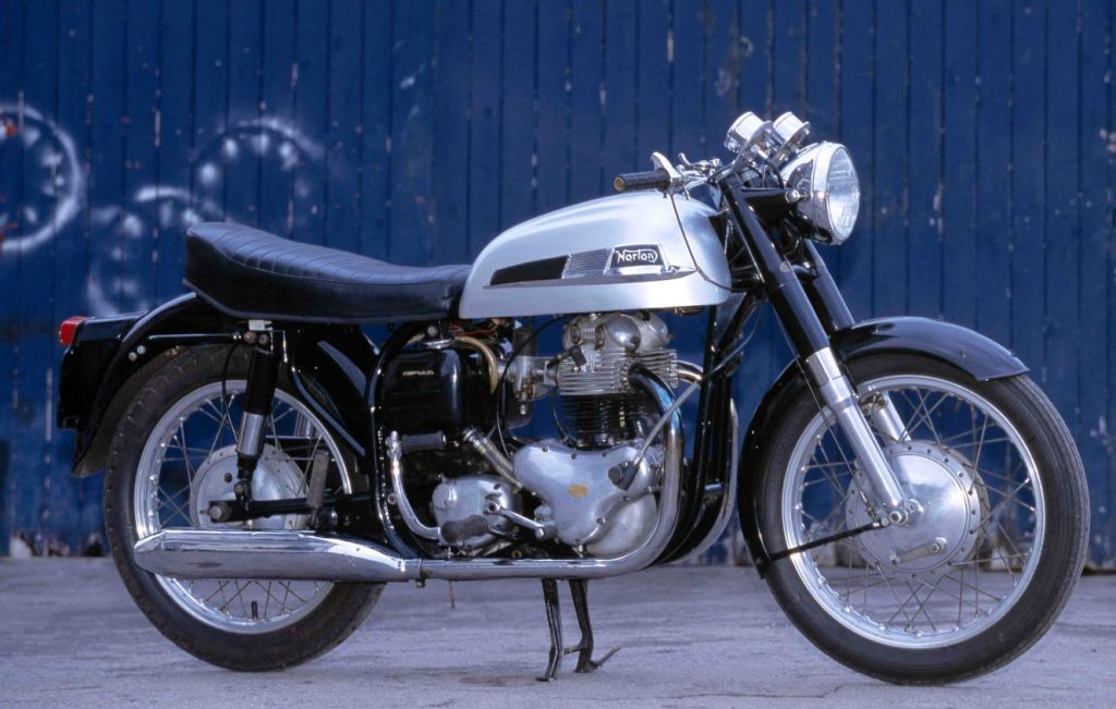 Norton Dominator 88 motorcycle parked outdoors, full right-side profile of restored classic British parallel twin