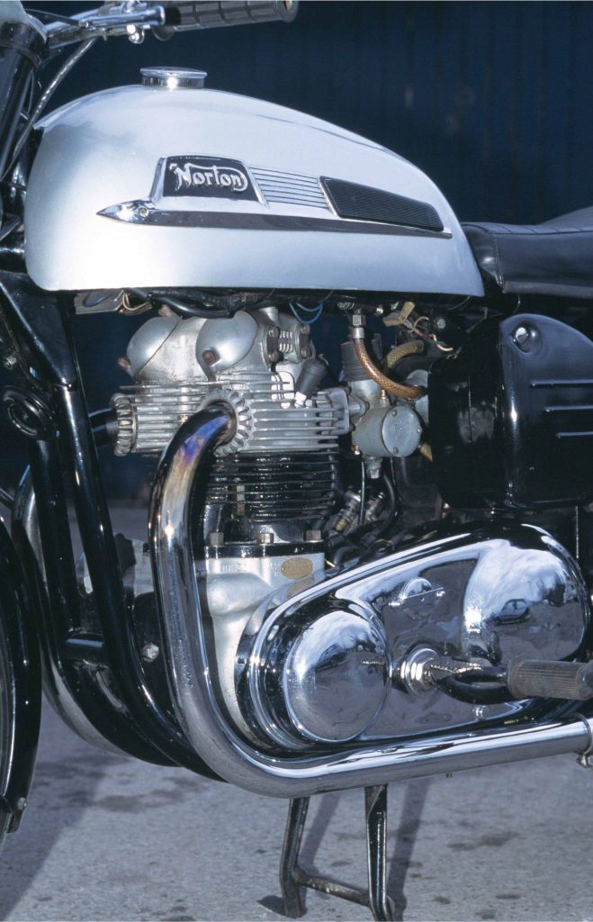 Norton Dominator 88 left side profile showing exhaust, engine and gearbox of restored 1950s British motorcycle