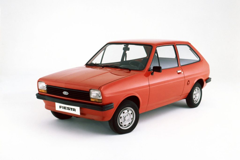 Original first-generation Ford Fiesta Mk1 in red, photographed in a studio against a white background
