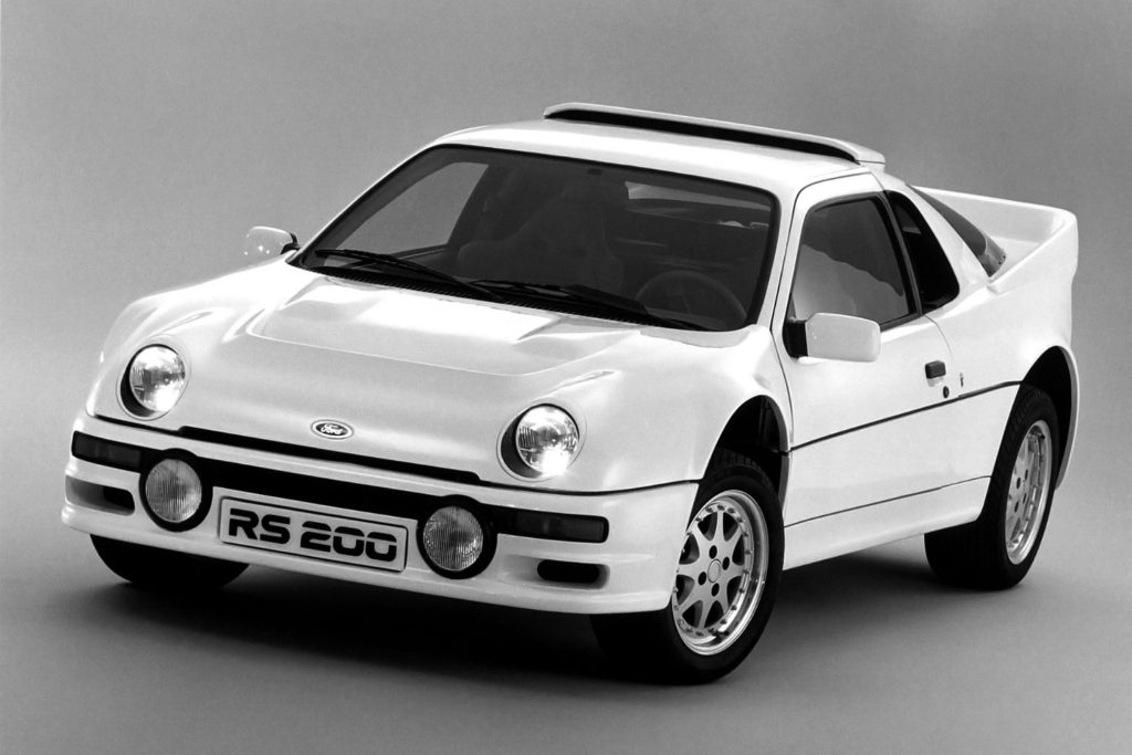 White Ford RS200 Group B rally car in a studio press photo, shot in black and white
