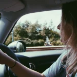 Young driving driving a classic car