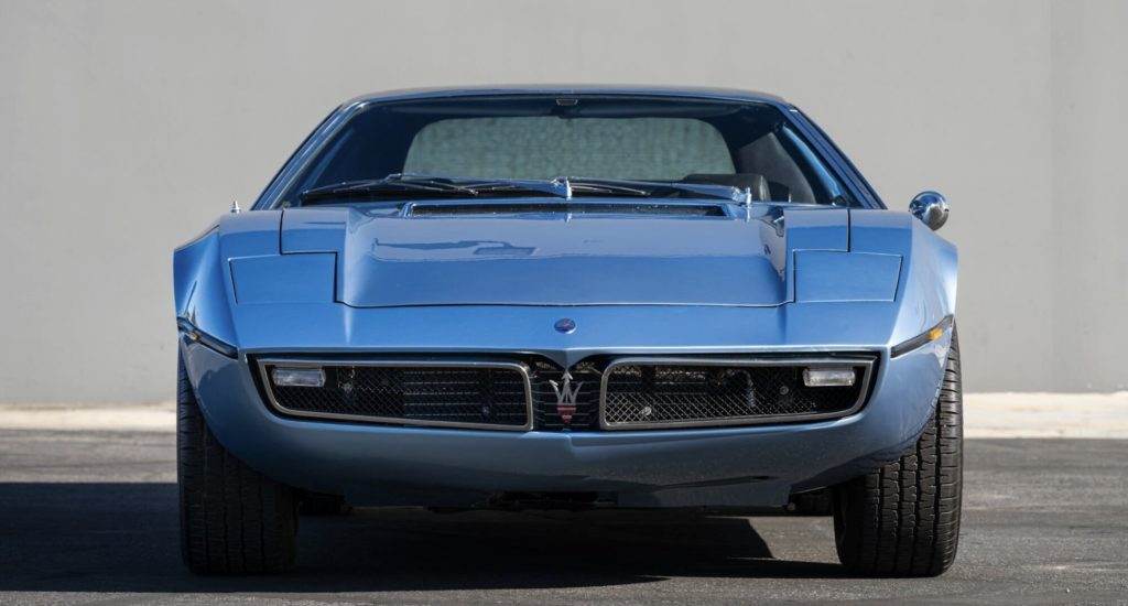 Straight-on front view of a light blue Maserati Bora