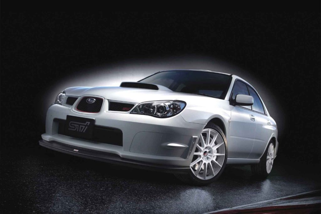 2006 Subaru Impreza WRX STI S204 in Pearl White studio photo showing front three-quarter view with STI front bumper and white multi-spoke wheels