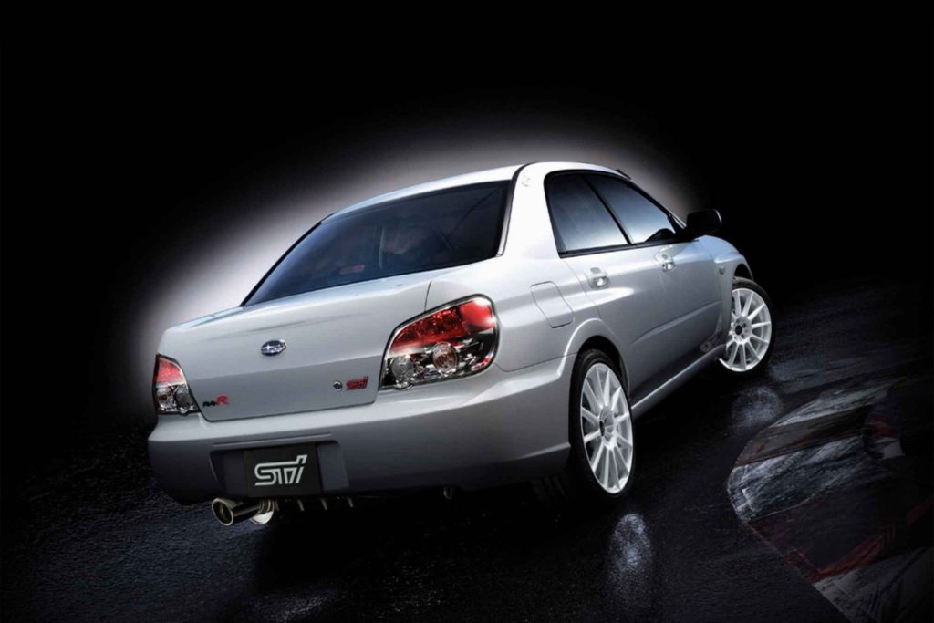 2006 Subaru Impreza WRX STI S204 RA-R in Pearl White studio rear three-quarter view showing STI badge and center exit exhaust