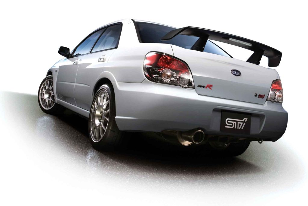 2006 Subaru Impreza WRX STI S204 RA-R in Pearl White rear three-quarter studio view showing large carbon rear wing and mesh alloy wheels