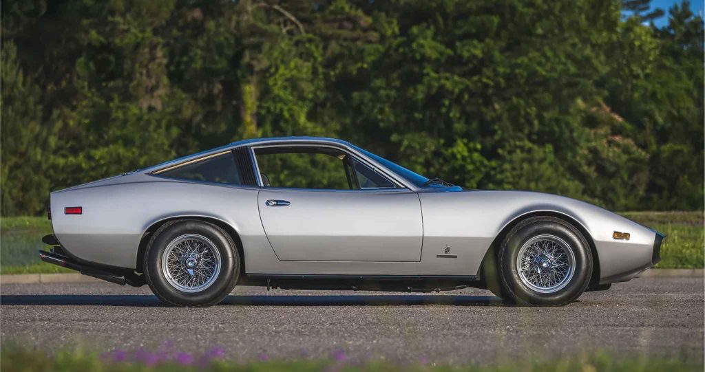 Side profile of a silver Ferrari 365 GTC/4 highlighting the long, low fastback silhouette, wire wheels, and minimal chrome detailing