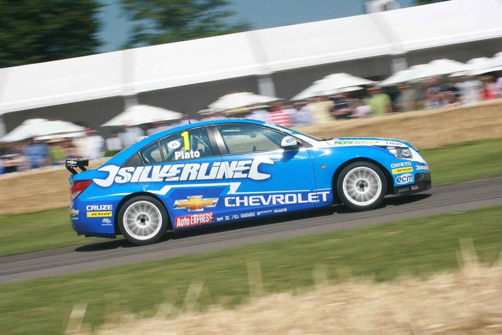 The Silverline Chevrolet Cruze BTCC race car driven by Jason Plato (car #1) captured in motion at what appears to be the Goodwood Festival of Speed, in full blue Chevrolet/Silverline livery.