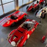 An overhead view of the Maserati Museum's racing gallery, showing multiple classic cars