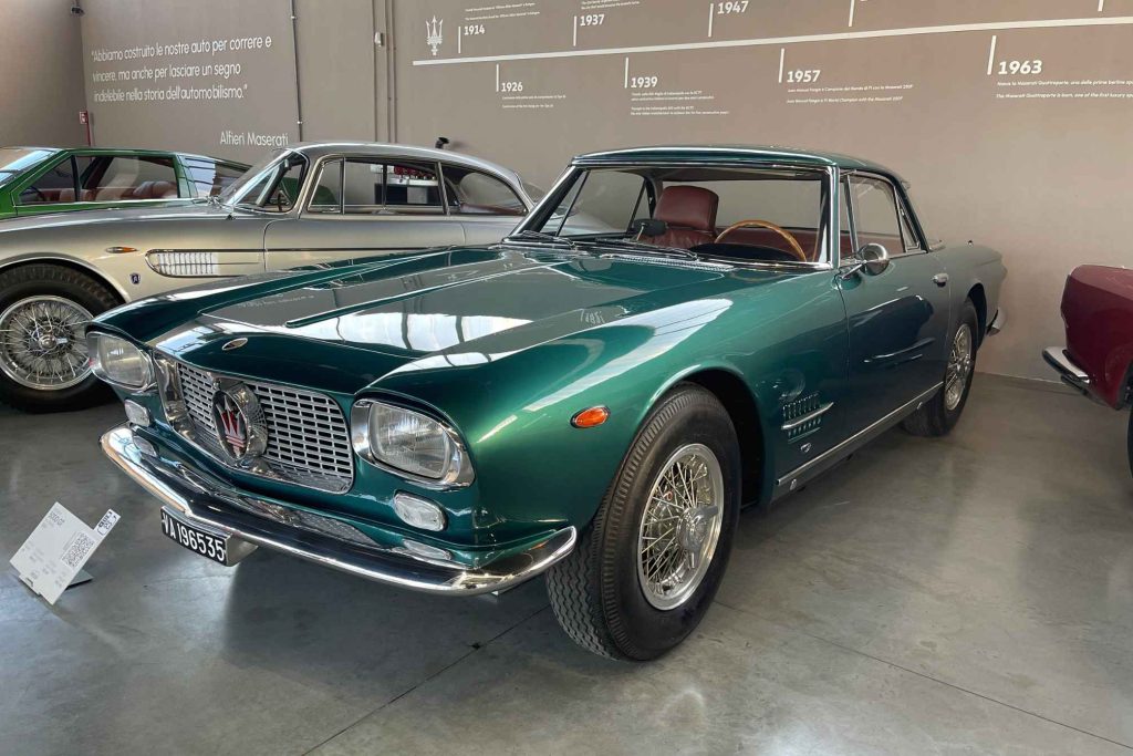 A dark green Maserati 5000 GT displayed in the Maserati Museum