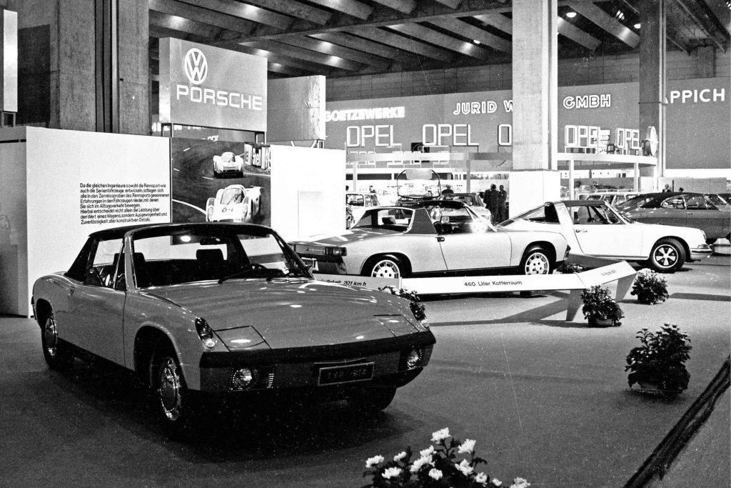 Black and white photo of the Porsche 914 Typ 914 on display at a motor show stand shared with Volkswagen