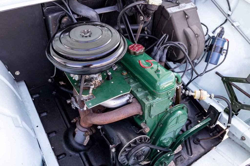 Engine bay of a Renault Floride showing the compact green-painted four-cylinder engine with round air filter, carburettor, and period-correct ancillaries including a Bougicord ignition system.