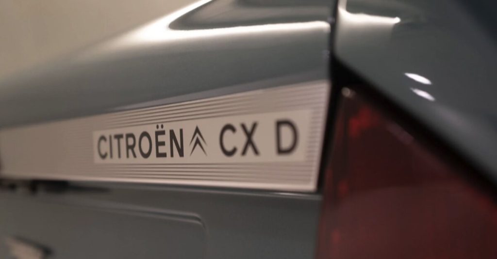 Close-up detail of the Citroën CX D rear badging on a brushed aluminium trim panel