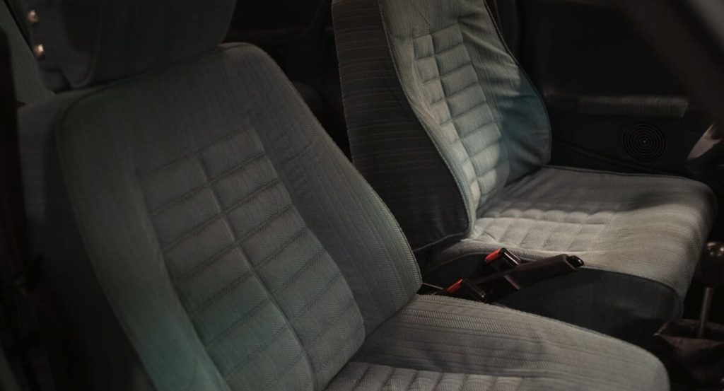 Detail shot of the Citroën CX front seats upholstered in green-grey diamond-pattern checked fabric