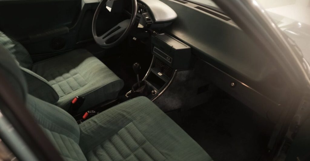 Citroën CX interior viewed from the passenger side showing green-grey checked fabric front seats