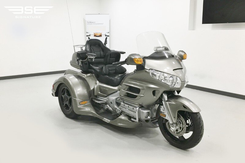 Silver Honda Gold Wing trike conversion photographed indoors at Signature Motor Company showroom.
