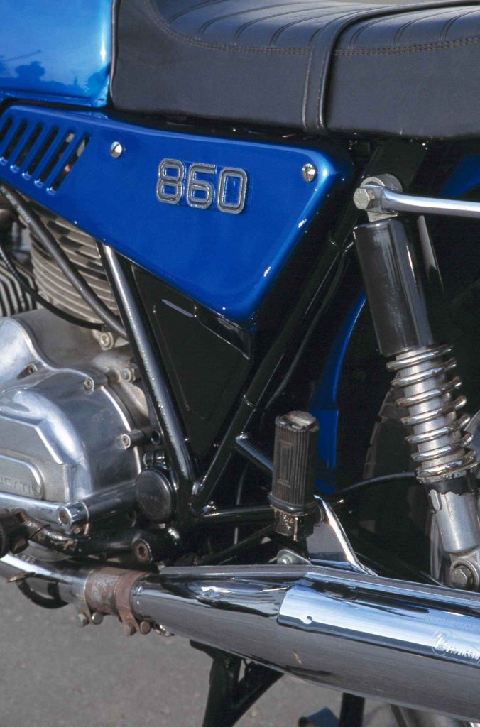 Ducati 860 side panel badge with vents, rear shock and frame detail